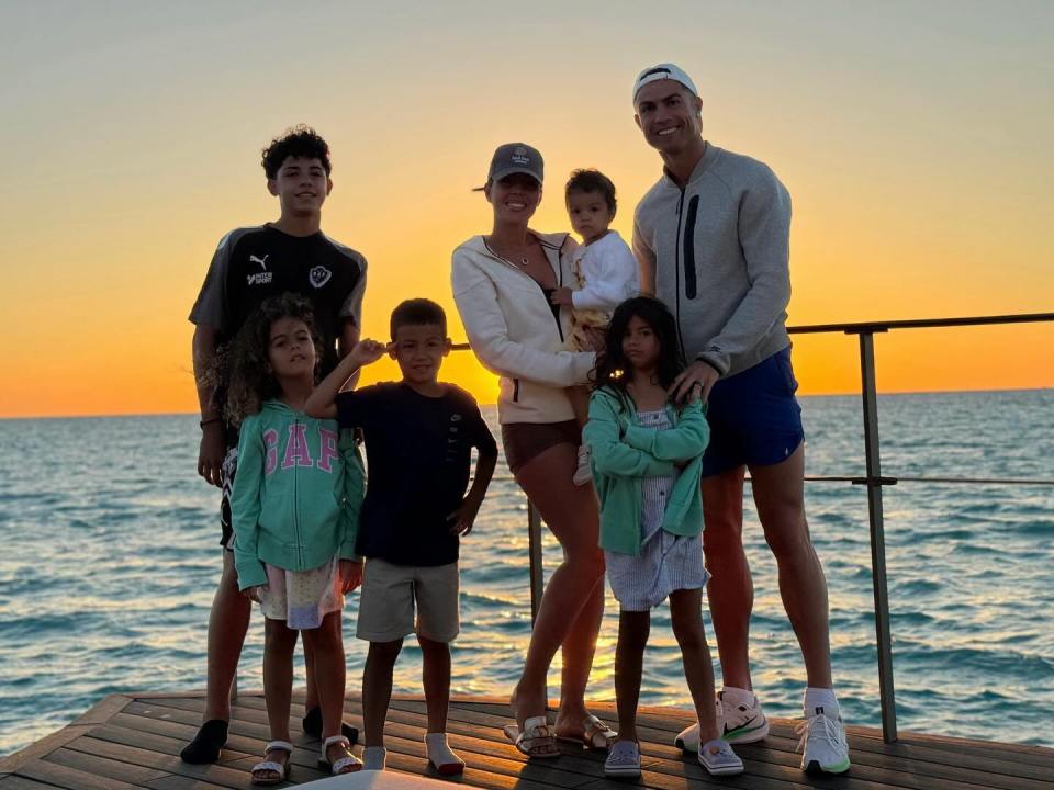 Cristiano Ronaldo and Georgina Rodriguez with their children at sunset.